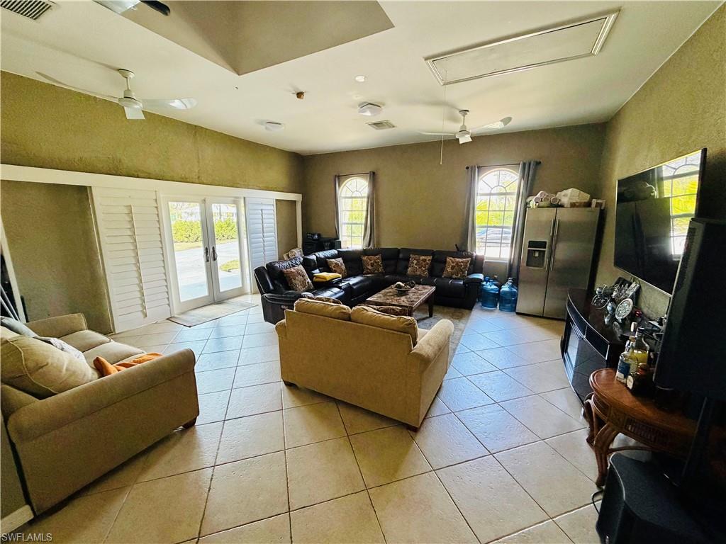 3960 1st Avenue Northwest Naples, FL 34119 - Photo 21 of 25 a living room with furniture and a flat screen tv