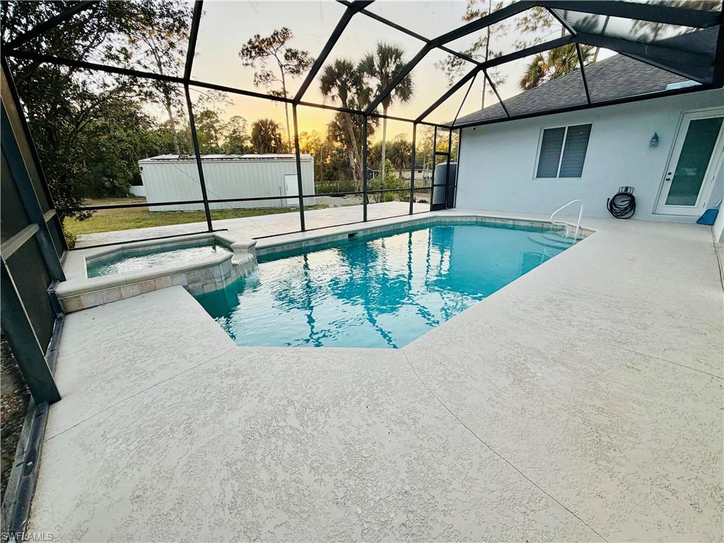 3960 1st Avenue Northwest Naples, FL 34119 - Photo 23 of 25 a view of a swimming pool with a yard