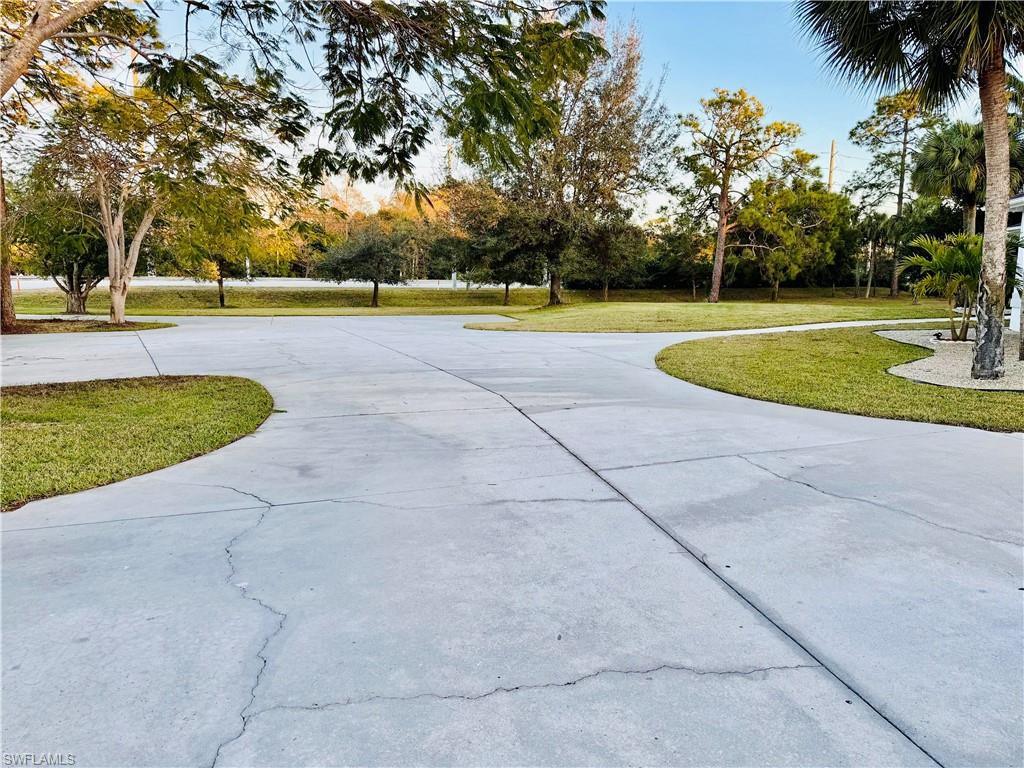 3960 1st Avenue Northwest Naples, FL 34119 - Photo 3 of 25 a view of a swimming pool and a yard