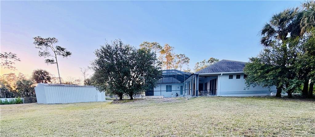3960 1st Avenue Northwest Naples, FL 34119 - Photo 5 of 25 a view of a house with a yard and tree s