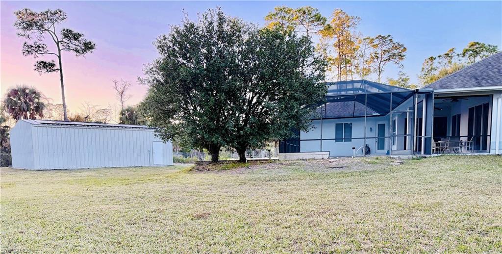 3960 1st Avenue Northwest Naples, FL 34119 - Photo 6 of 25 a house with trees in front of it