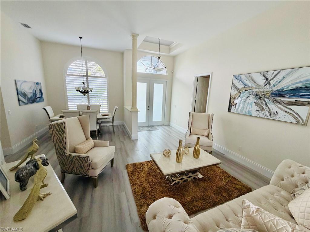 3960 1st Avenue Northwest Naples, FL 34119 - Photo 8 of 25 a living room with furniture and a wooden floor