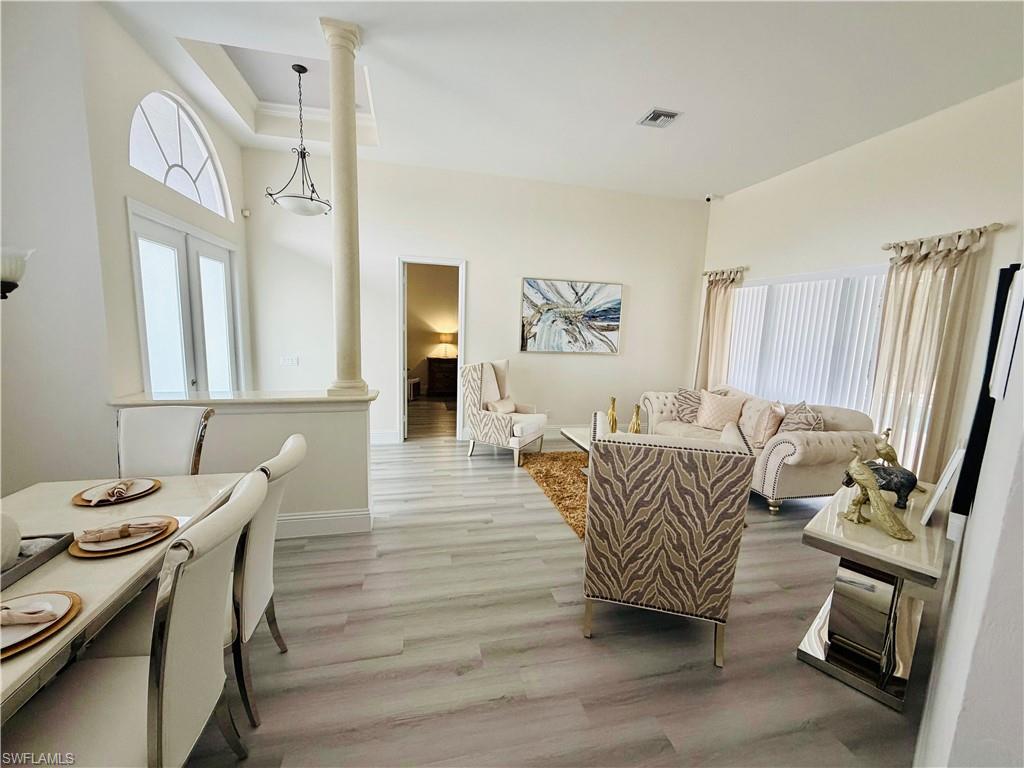 3960 1st Avenue Northwest Naples, FL 34119 - Photo 9 of 25 a living room with furniture a fireplace and a flat screen tv