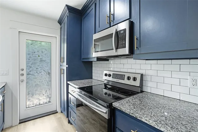 a kitchen with a stove microwave and sink