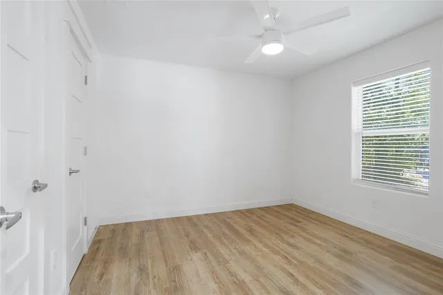 wooden floor in an empty room with a window