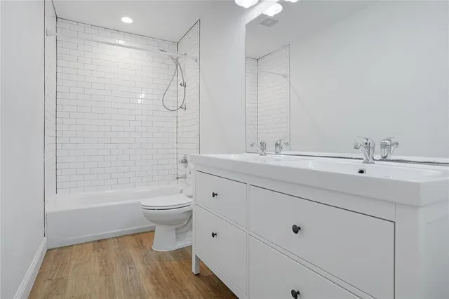 a bathroom with a double vanity sink toilet and shower