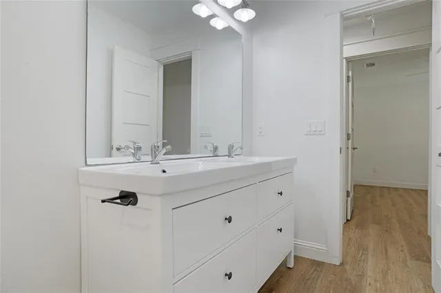a bathroom with a sink vanity and a mirror