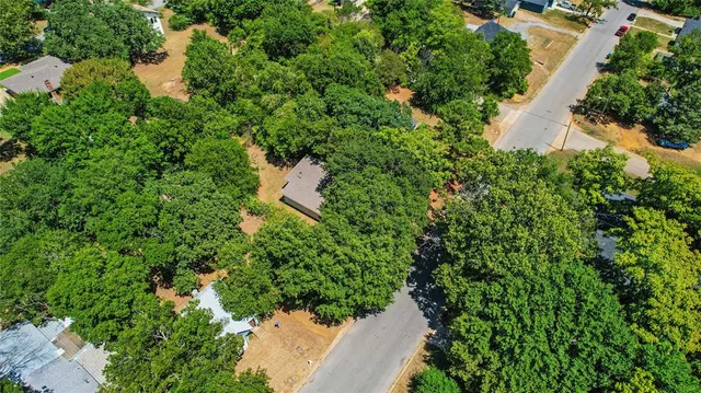 an aerial view of a house with a yard and lake view