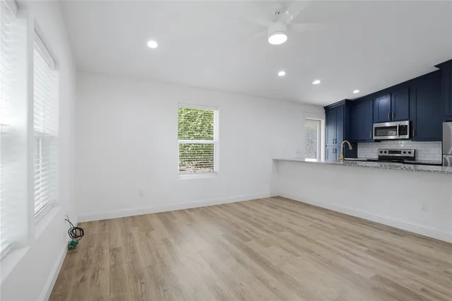 a view of kitchen with window and wooden floor