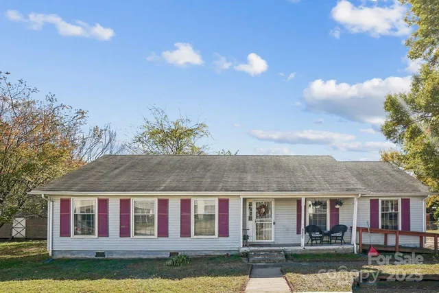 a view of a house with a garden and yard