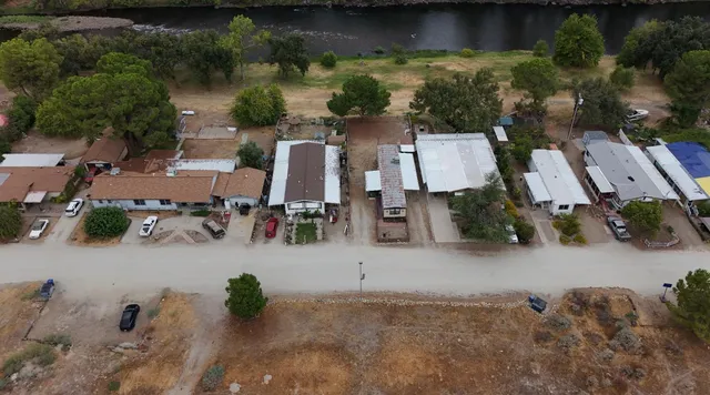 an aerial view of a house with garden space and street view