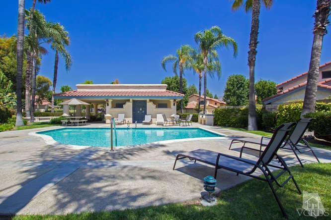 2711 Simi Hills Lane Simi Valley, CA 93063 - Photo 18 of 20 a view of a patio with a table and chairs under an umbrella