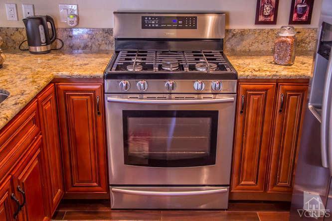 2711 Simi Hills Lane Simi Valley, CA 93063 - Photo 3 of 20 a stove top oven sitting inside of a kitchen