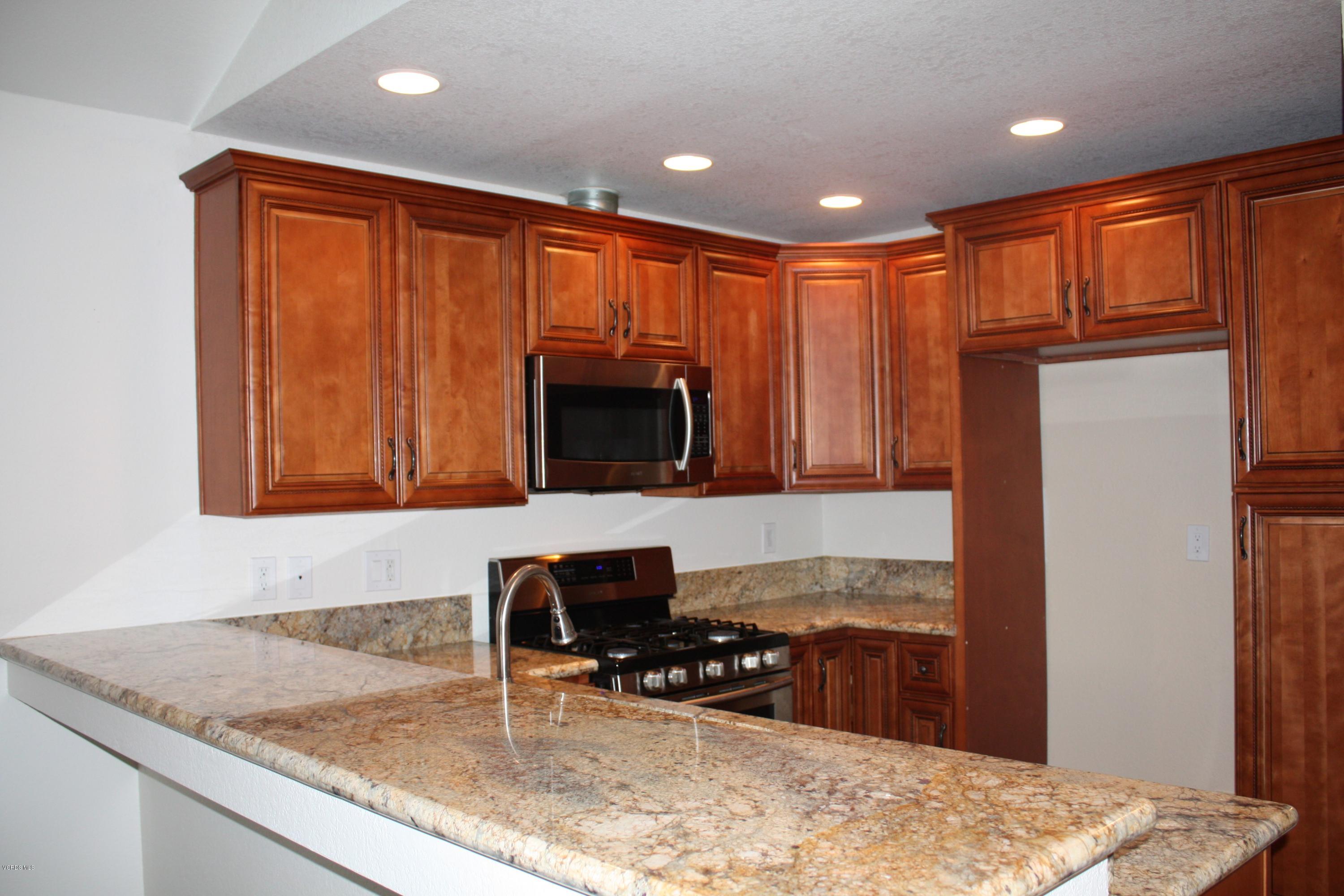 2711 Simi Hills Lane Simi Valley, CA 93063 - Photo 4 of 20 a kitchen with a refrigerator a stove a sink and a microwave