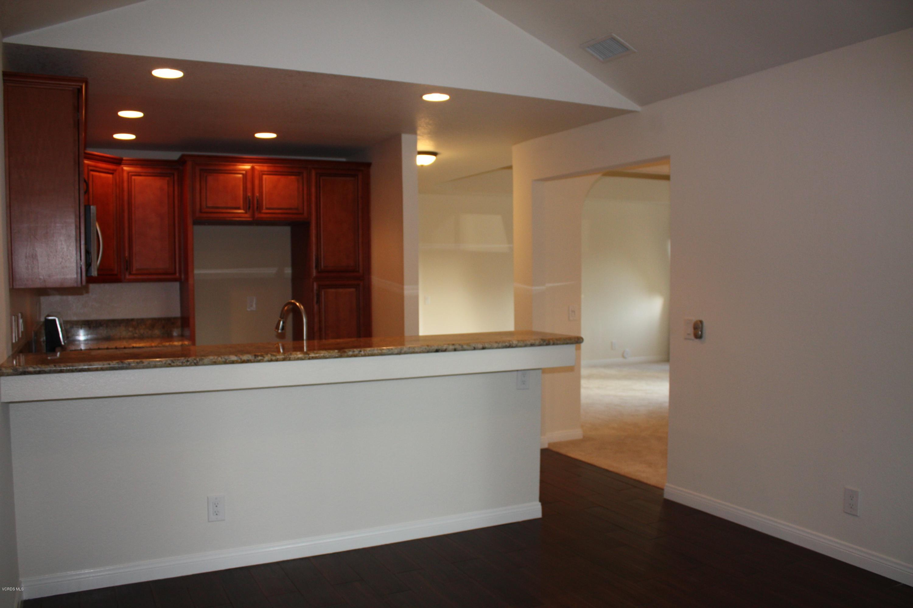 2711 Simi Hills Lane Simi Valley, CA 93063 - Photo 5 of 20 a view of a kitchen with a sink and a large window