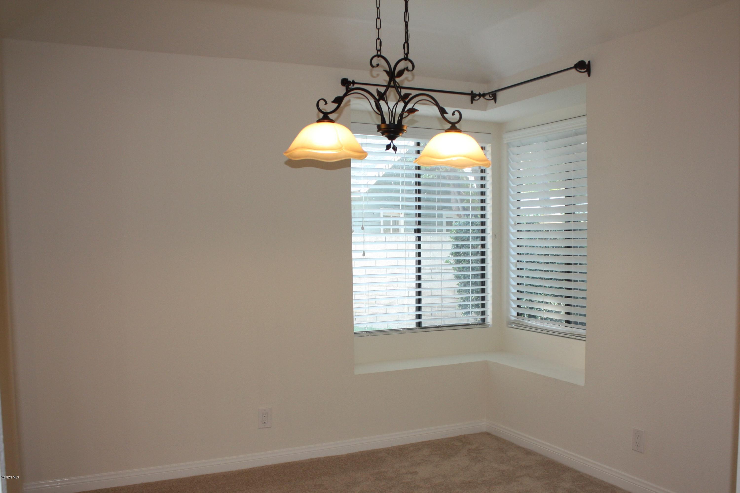 2711 Simi Hills Lane Simi Valley, CA 93063 - Photo 9 of 20 a room with window and a chandelier
