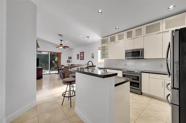 a kitchen with stainless steel appliances a stove a sink and a microwave