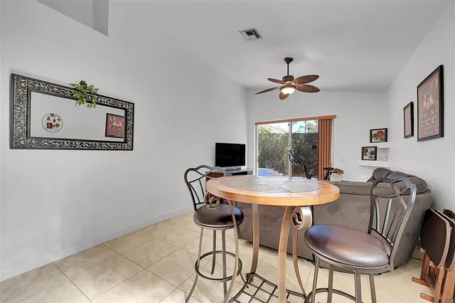 a living room with furniture kitchen and a chandelier