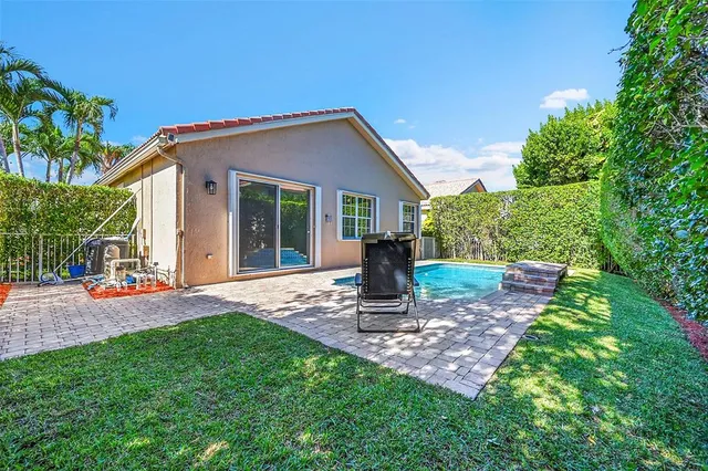an aerial view of residential houses with outdoor space and river