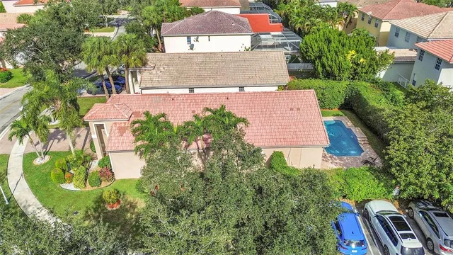 an aerial view of house with yard and mountain view in back