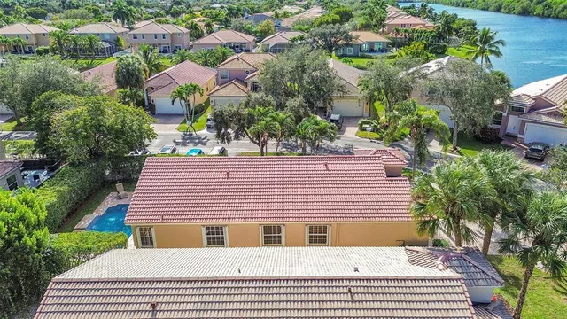 an aerial view of residential houses with outdoor space and river