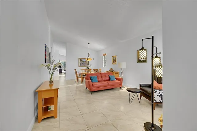a living room with furniture a rug and a window
