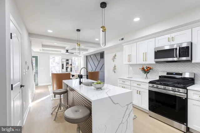 a living room with furniture a chandelier and a window