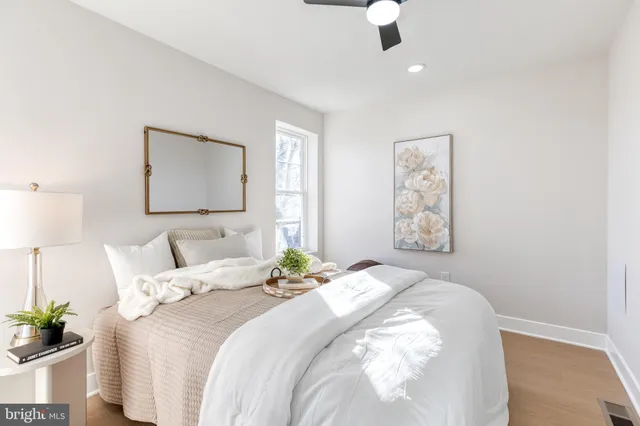 a bathroom with a sink a toilet a mirror and shower