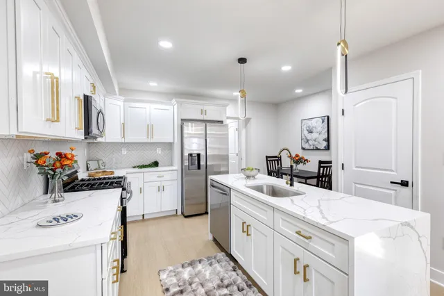 a kitchen with stainless steel appliances a stove a microwave and cabinets