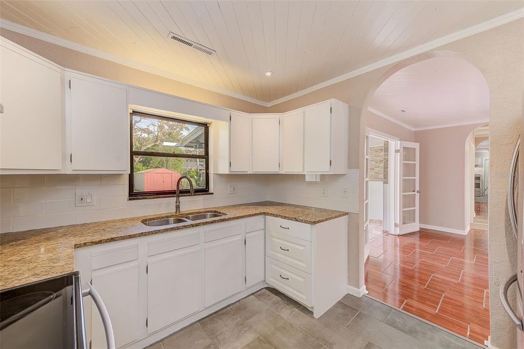 1668 Cleveland Street Clearwater, FL 33755 - Photo 12 of 31 a kitchen with a sink cabinets and window
