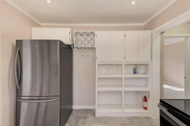 a room with a refrigerator and cabinets