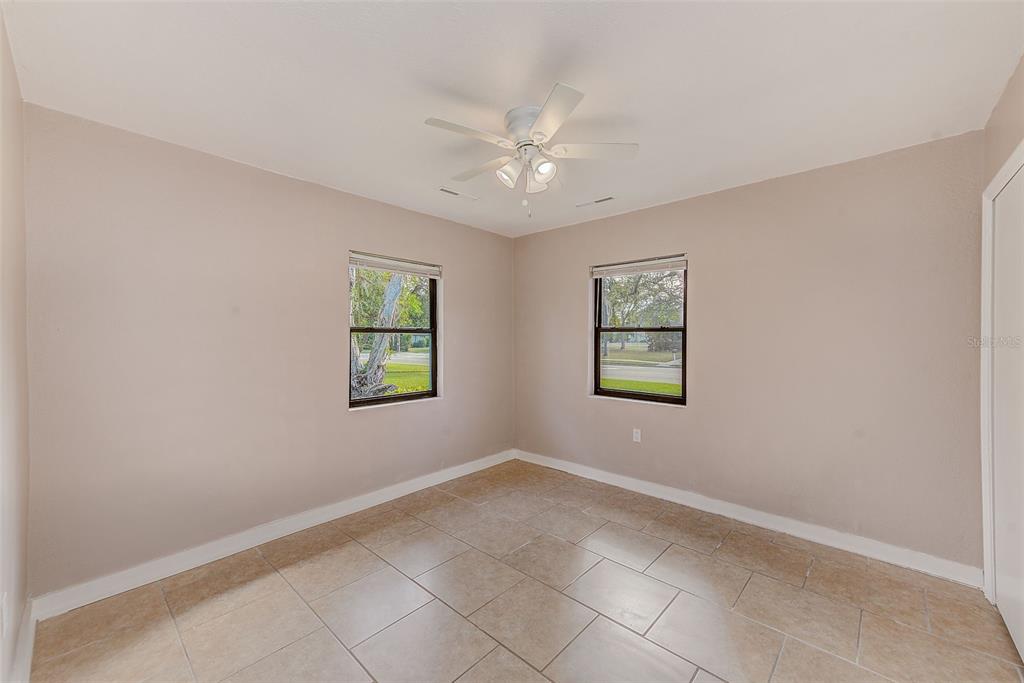 1668 Cleveland Street Clearwater, FL 33755 - Photo 17 of 31 an empty room with windows and fan