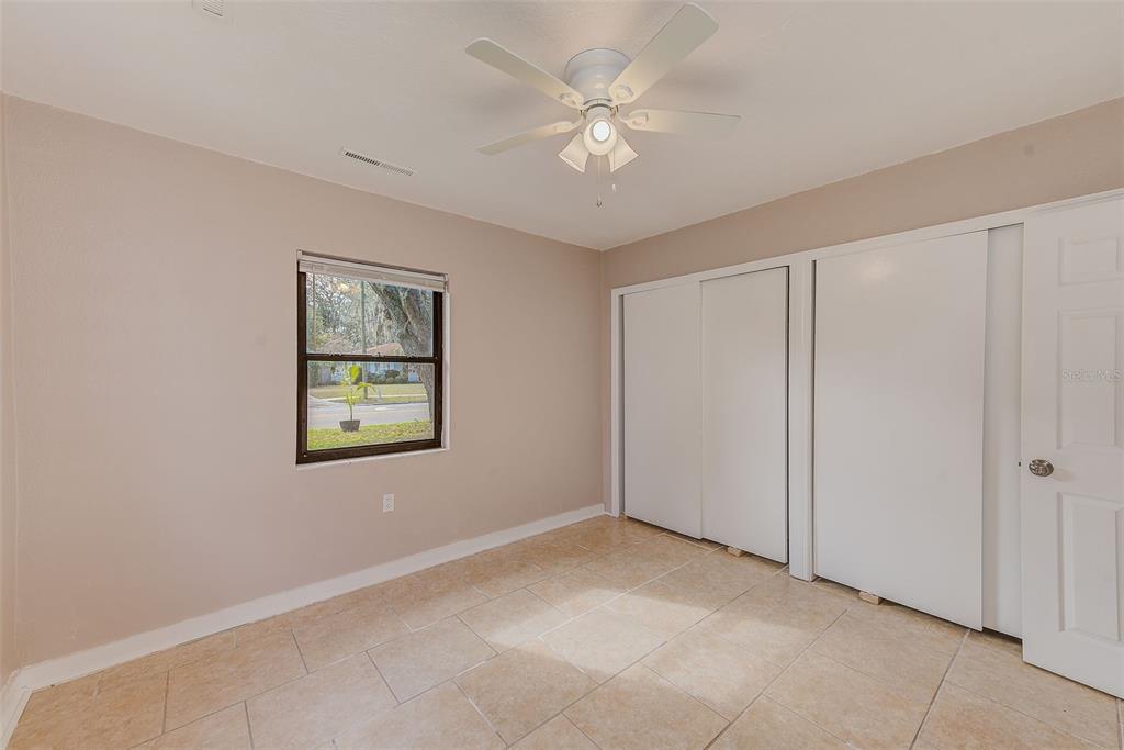 1668 Cleveland Street Clearwater, FL 33755 - Photo 18 of 31 an empty room with windows and fan