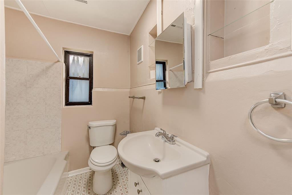 1668 Cleveland Street Clearwater, FL 33755 - Photo 19 of 31 a bathroom with a sink toilet and mirror