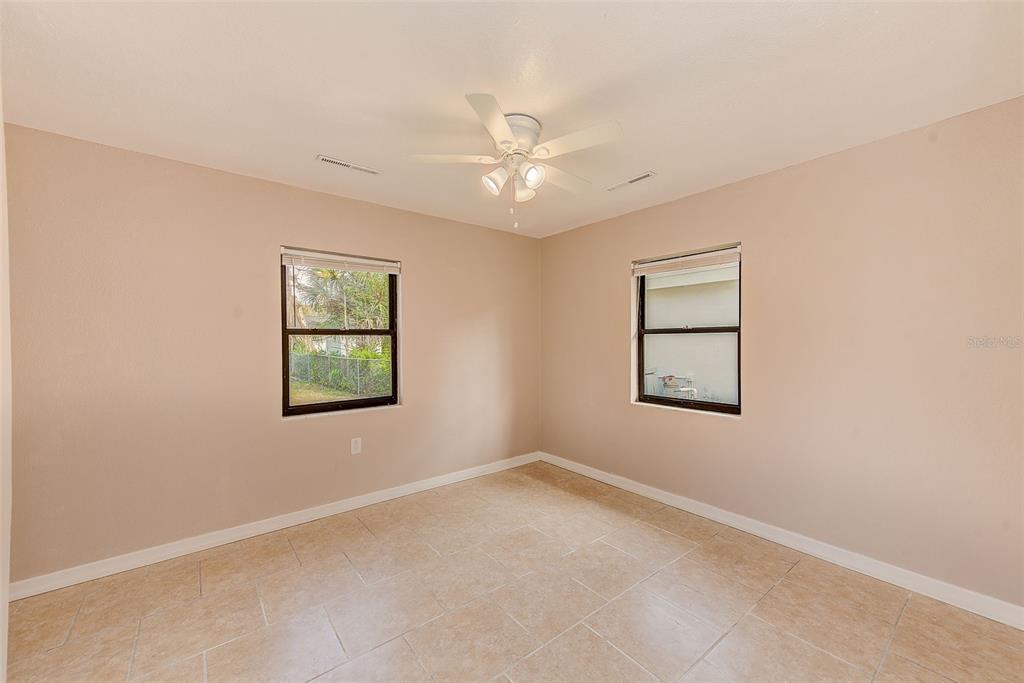 1668 Cleveland Street Clearwater, FL 33755 - Photo 20 of 31 an empty room with a window and a fan