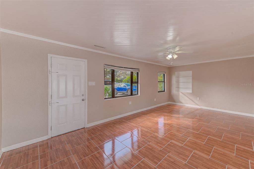 1668 Cleveland Street Clearwater, FL 33755 - Photo 2 of 31 a view of an empty room with window and wooden floor