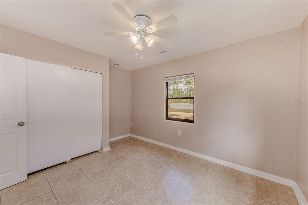 1668 Cleveland Street Clearwater, FL 33755 - Photo 21 of 31 an empty room with windows and fan