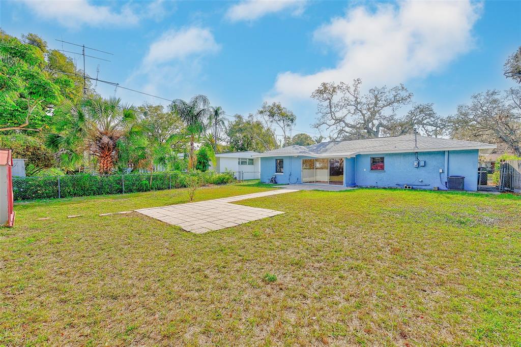 1668 Cleveland Street Clearwater, FL 33755 - Photo 28 of 31 a view of a house with swimming pool and a yard