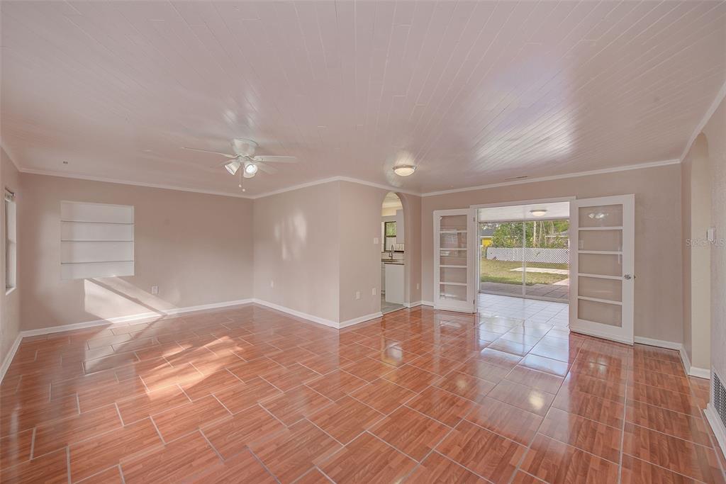 1668 Cleveland Street Clearwater, FL 33755 - Photo 4 of 31 a view of an empty room with wooden floor and a window