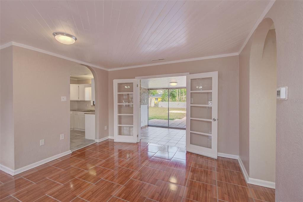 1668 Cleveland Street Clearwater, FL 33755 - Photo 6 of 31 wooden floor in an empty room with a window
