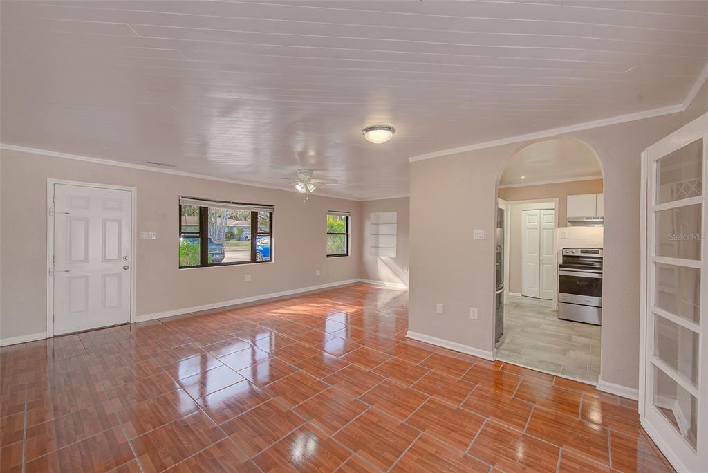 1668 Cleveland Street Clearwater, FL 33755 - Photo 7 of 31 an empty room with wooden floor and windows