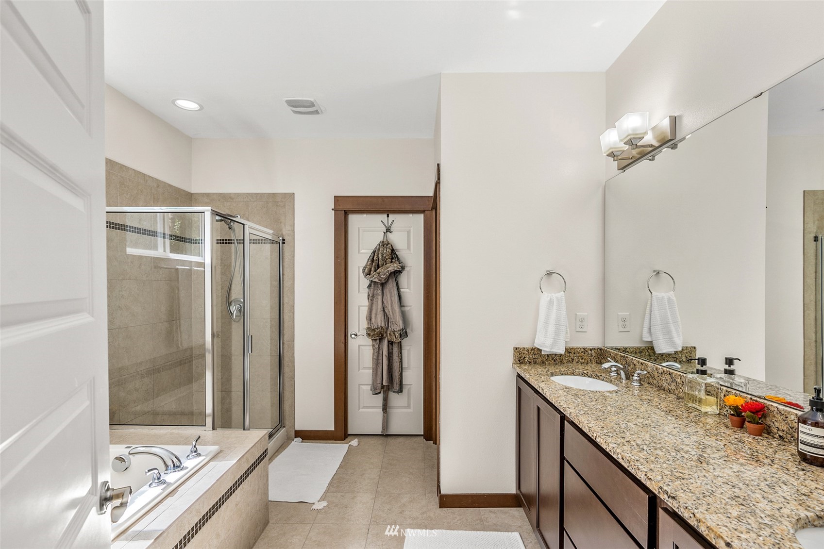 23014 19th Place West Bothell, WA 98021 - Photo 31 of 40 a bathroom with a granite countertop sink a mirror and a bathtub