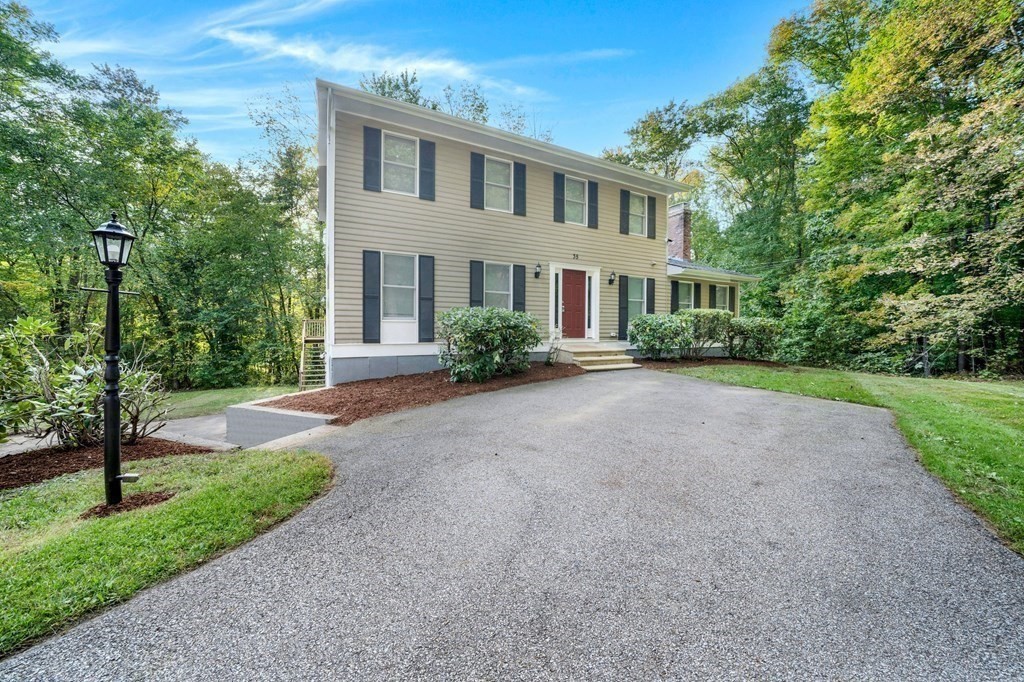35 Old Village Road Sturbridge, MA 01566 - Photo 3 of 39 a front view of a house with a yard and trees