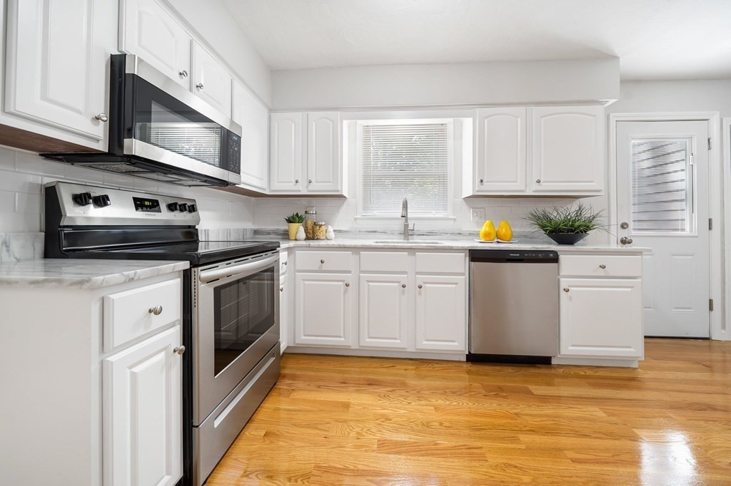 35 Old Village Road Sturbridge, MA 01566 - Photo 5 of 39 a kitchen with stainless steel appliances granite countertop a sink a stove a refrigerator cabinets and a window