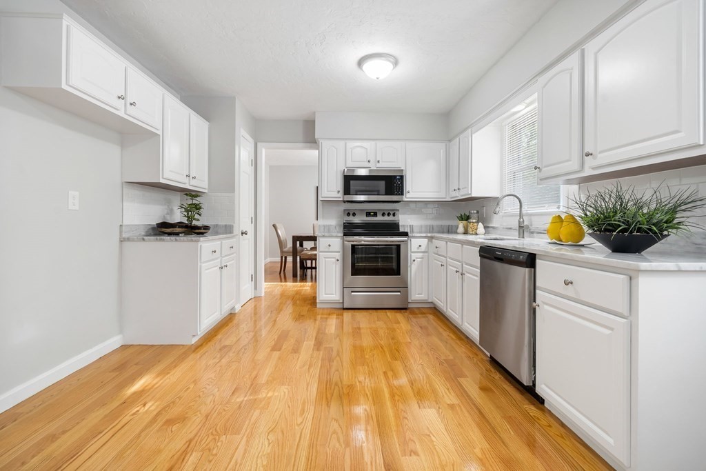 35 Old Village Road Sturbridge, MA 01566 - Photo 7 of 39 a kitchen with stainless steel appliances kitchen island wooden cabinets and granite counter tops