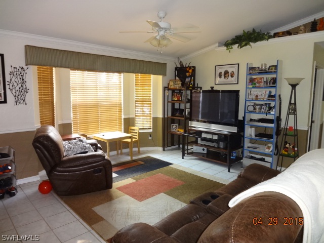 8394 Bamboo Road Fort Myers, FL 33967 - Photo 4 of 25 a living room with furniture a flat screen tv and a large window