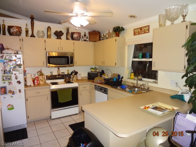 8394 Bamboo Road Fort Myers, FL 33967 - Photo 6 of 25 a kitchen with a sink a stove and chairs