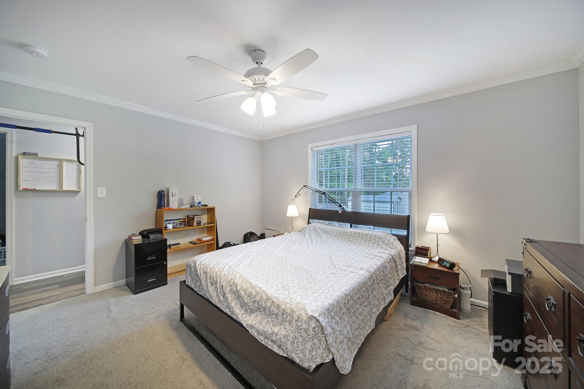 2302 Douglas Road Lancaster, SC 29720 - Photo 14 of 30 a bedroom with a bed and a chandelier