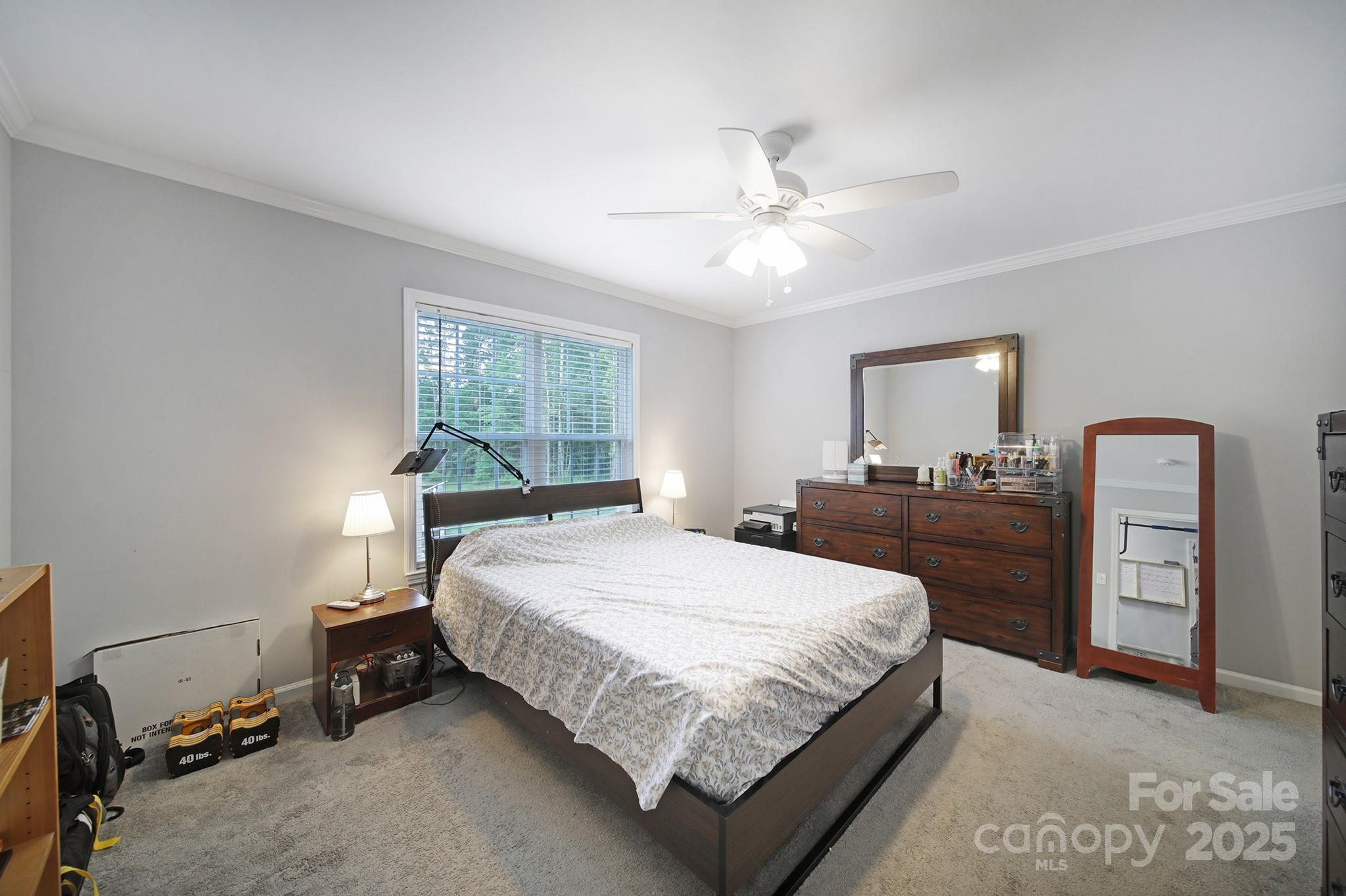 2302 Douglas Road Lancaster, SC 29720 - Photo 16 of 30 a bedroom with a large bed and a chandelier