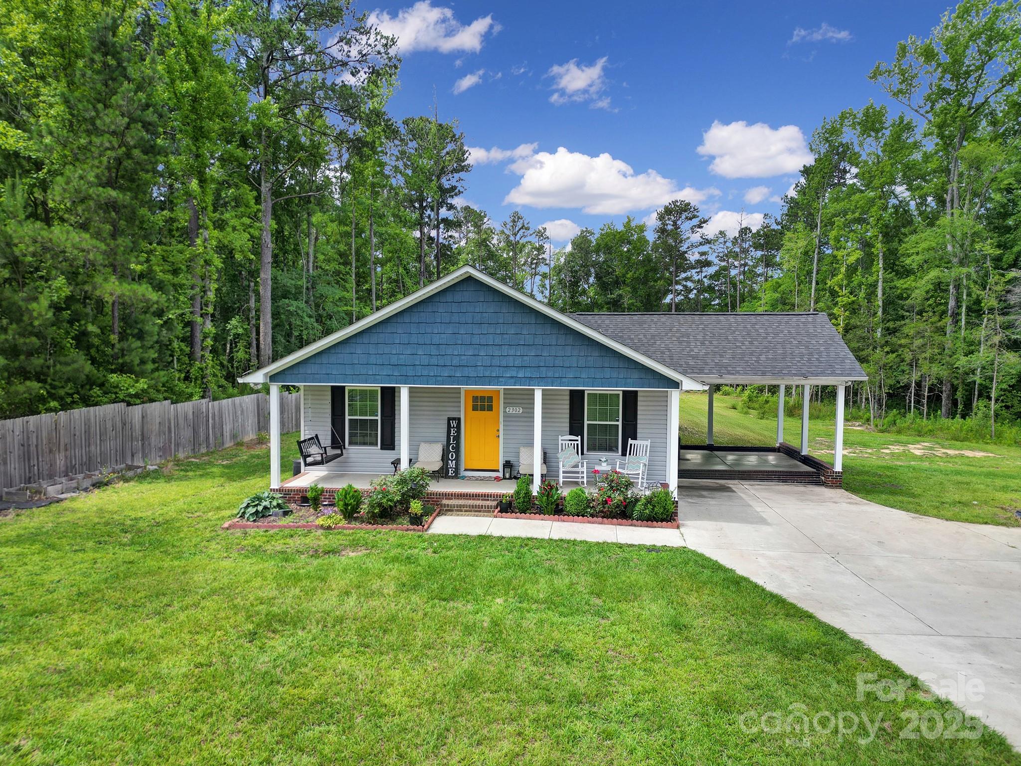 2302 Douglas Road Lancaster, SC 29720 - Photo 2 of 30 a backyard of a house with table and chairs